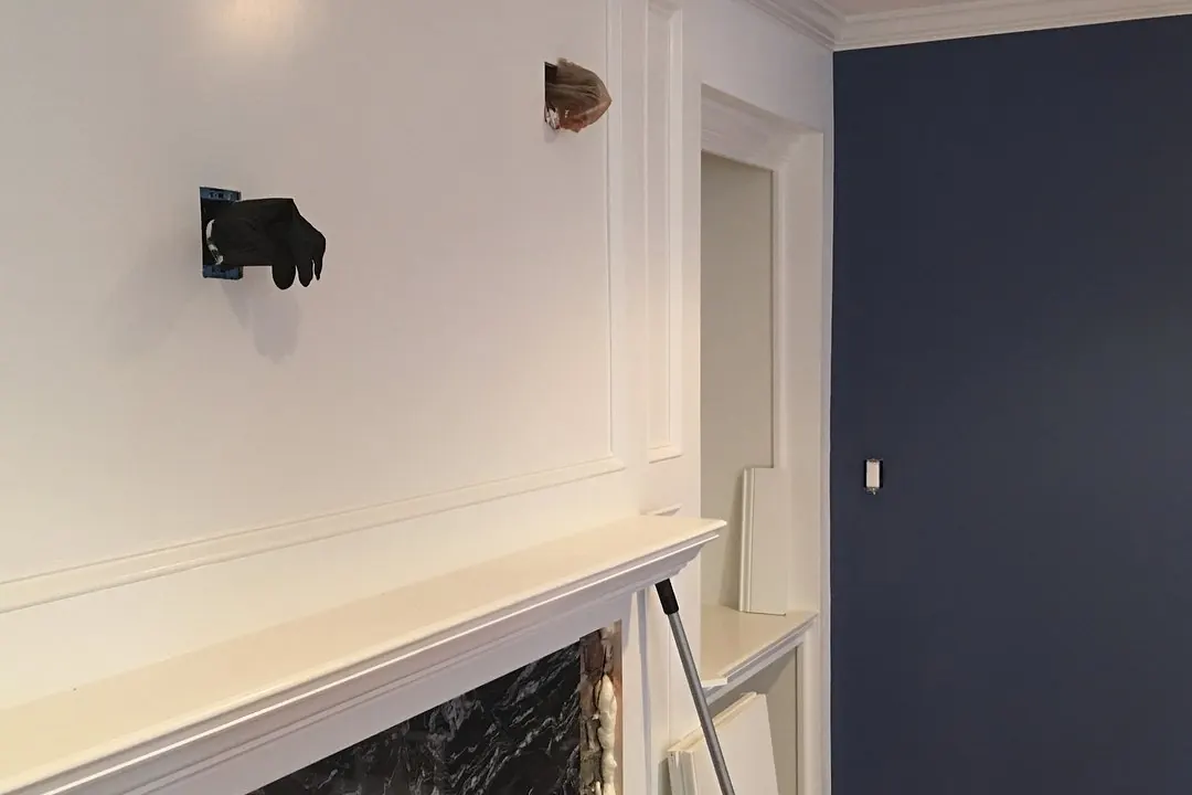 Navy accent wall and white fireplace trim in Middlesex, NJ